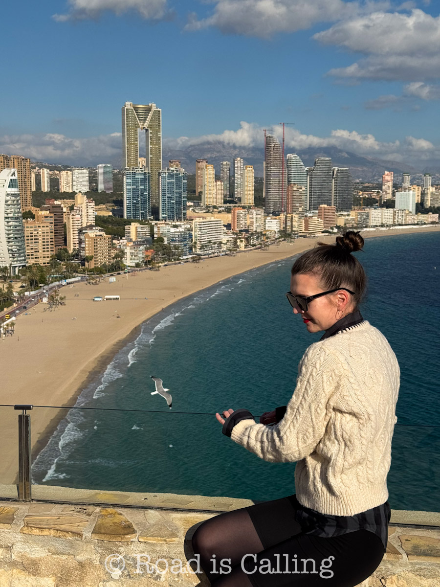 Benidorm in winter with a person overlooking the coastline and Mediterranean Sea