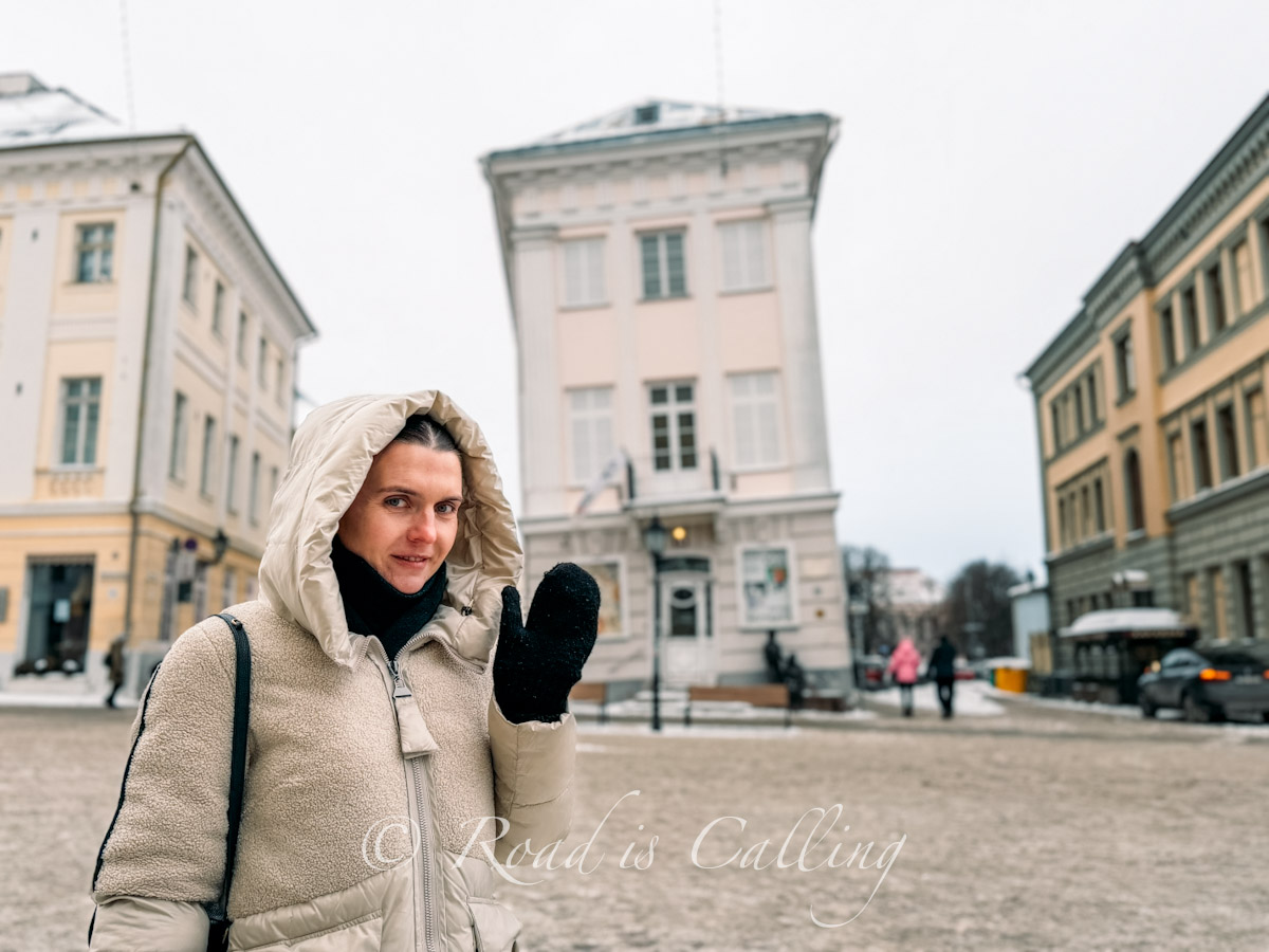 me standing by the leaning buidling on the main square in Tartu