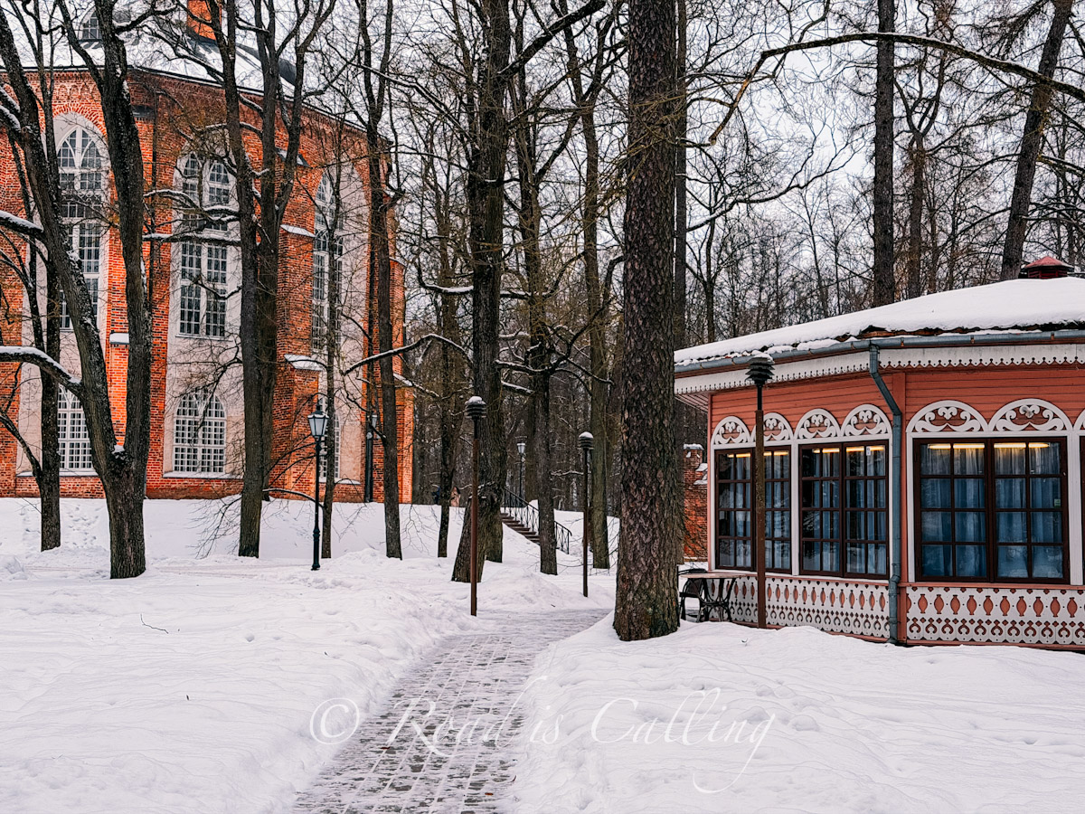 red brick Gothic church and Rotund cafe building on Toome Hill surrounded by snow and trees