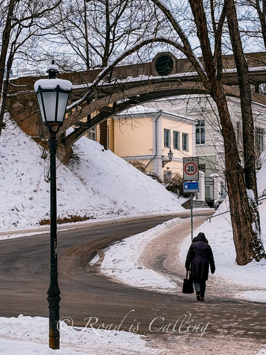 woman walking across the road by the Devil's Bridge in Tartu