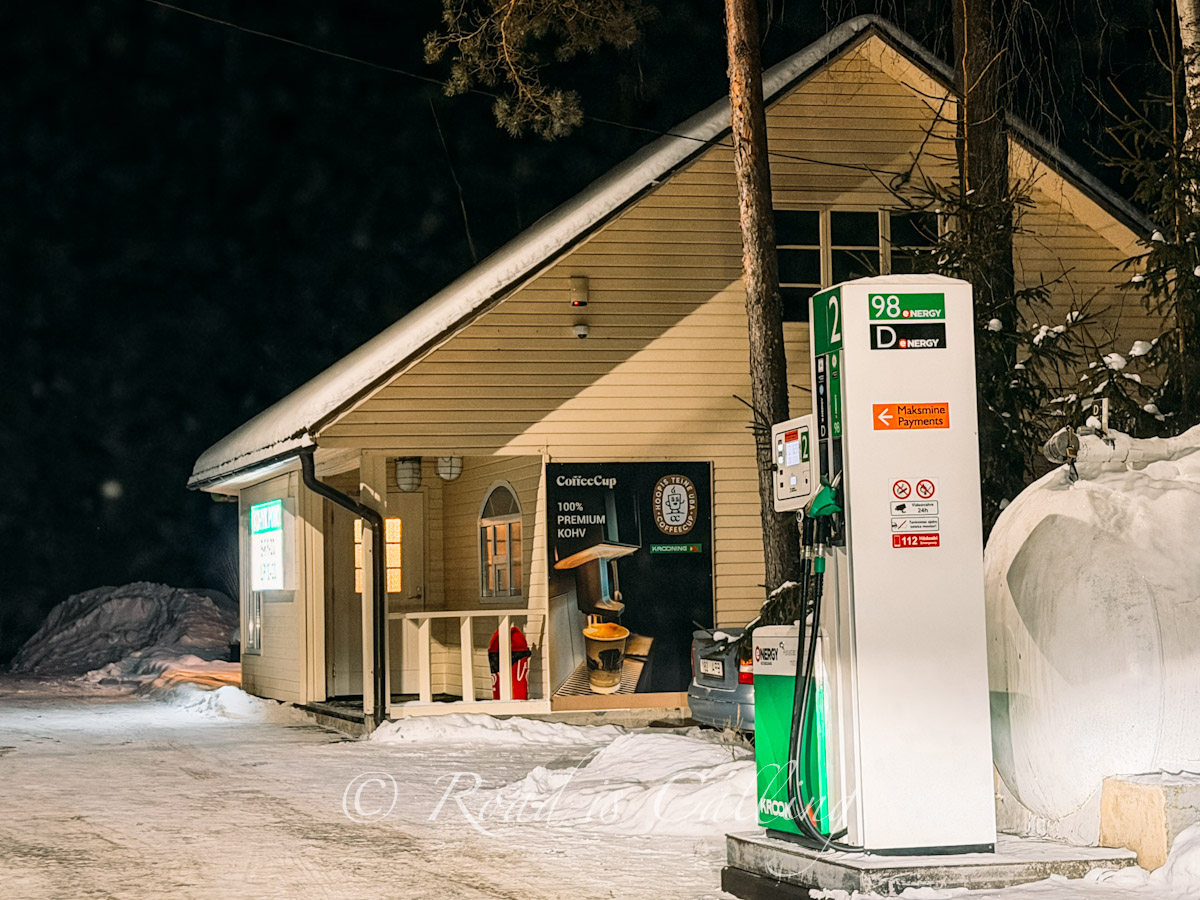 snowy petrol station with small wooden cafe in Lahemaa National Park, Estonia, at night