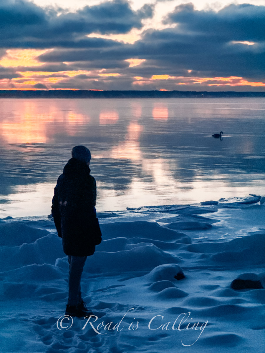 man standing on the snowy beach by the Baltic Sea in Loksa, Estonia