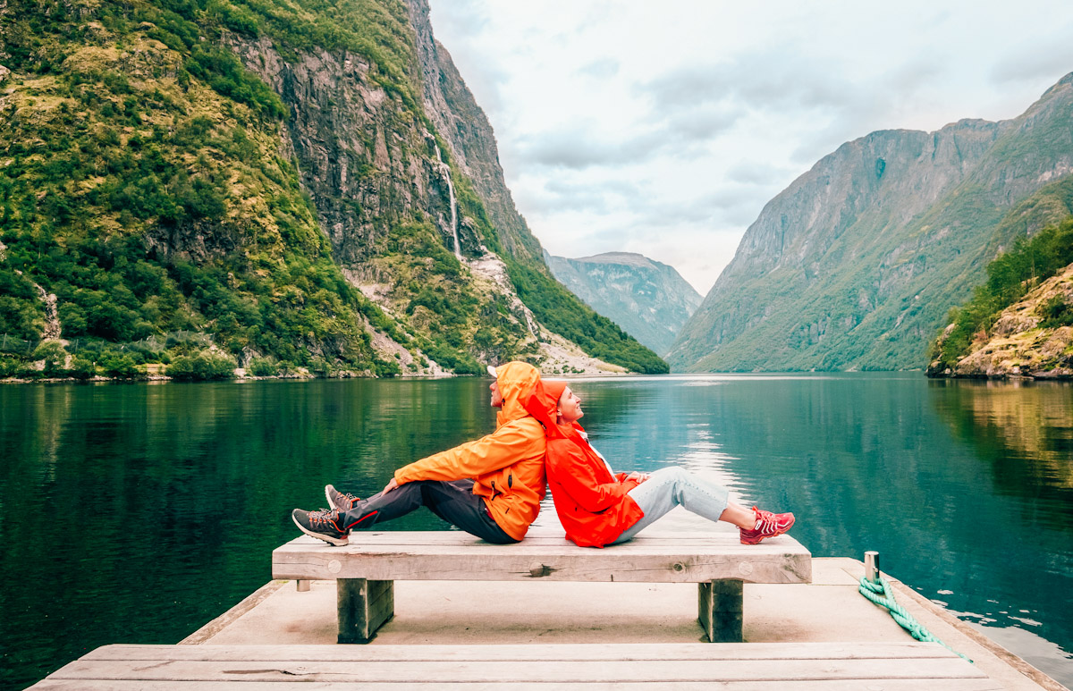 couple sitting on a bench with Næroyfjord view in Norway
