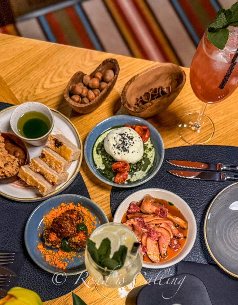 Table with shared dishes at Ugandi Resto in Otepaa showing a variety of local food and drinks