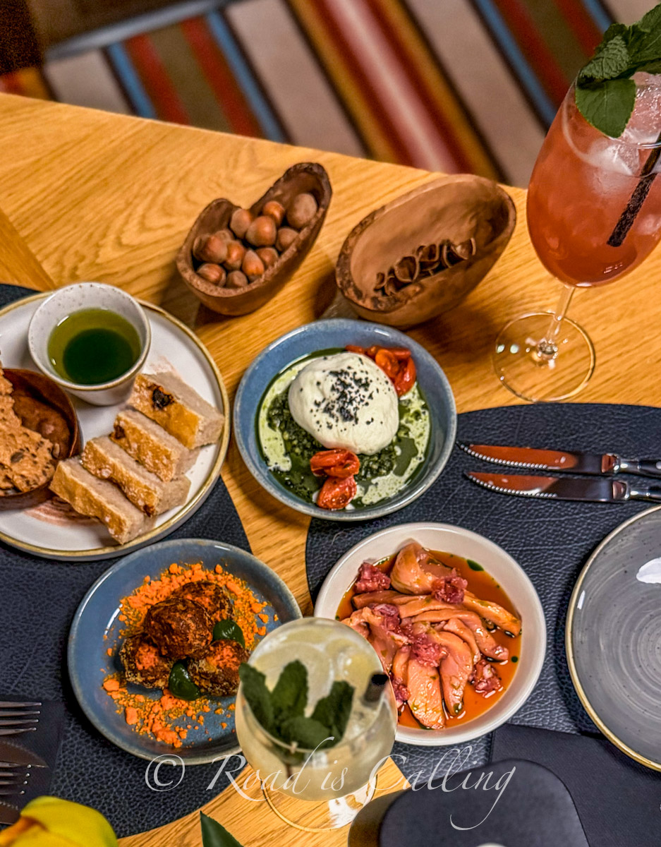 Table with shared dishes at Ugandi Resto in Otepaa showing a variety of local food and drinks