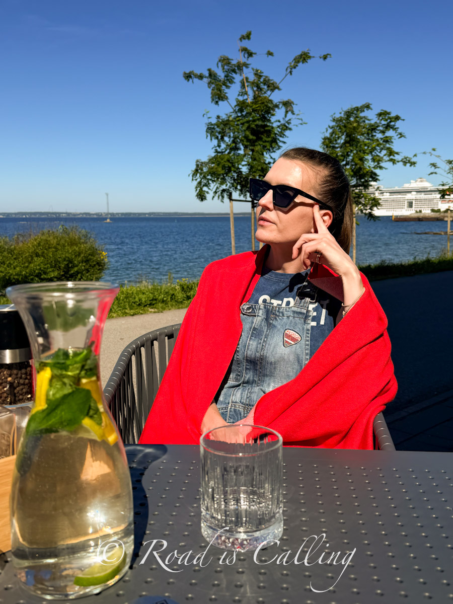 Me sitting at an outdoor table with drinks at a seaside cafe in Tallinn during 2 days