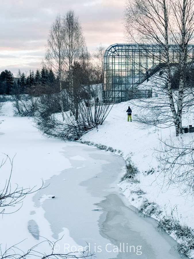 Frozen river and glass arctic museum building in Rovaniemi Finland