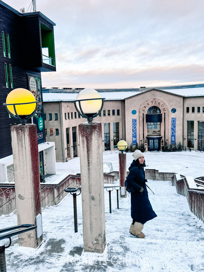 Me walking snowy stairs outside Arktikum Museum as part of 7 days in Lapland itinerary