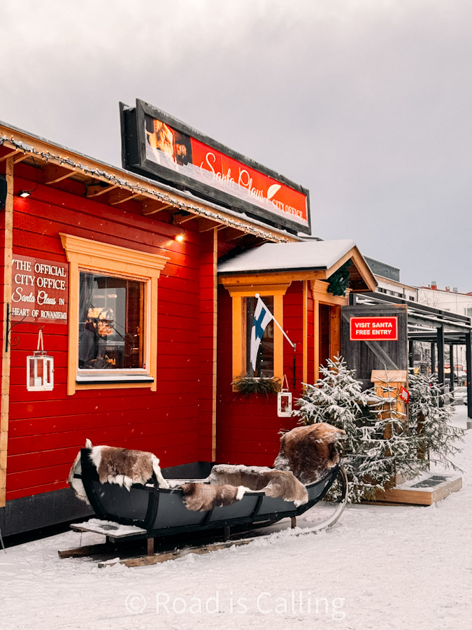 Red wooden Santa Claus City Office cabin with sleigh outside in Rovaniemi Finland