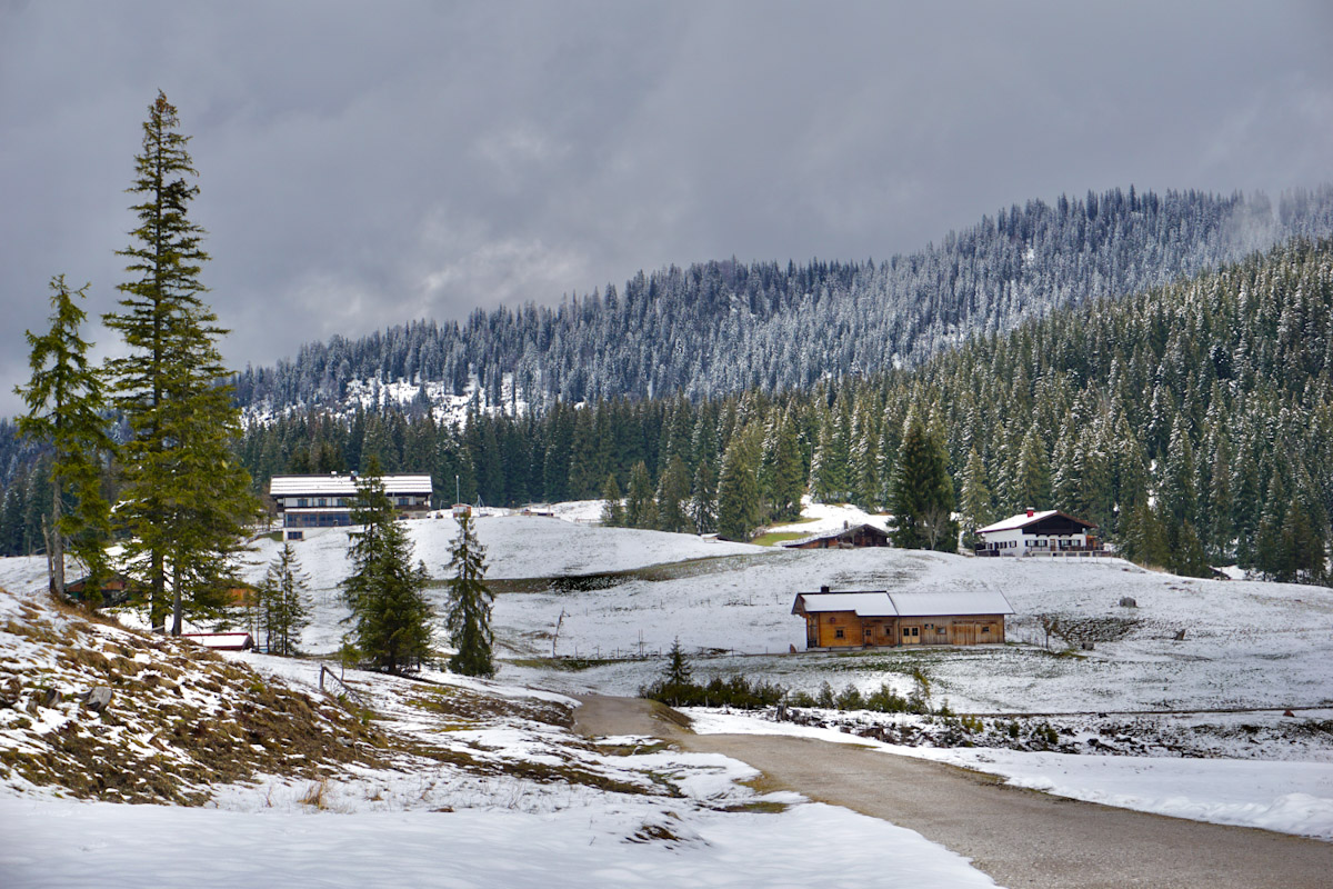 Snowy alpine landscape with remote Bavarian farmhouses in the mountains