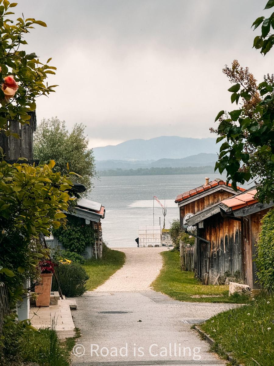 view of the lake, houses, and mountains in the background from the island
