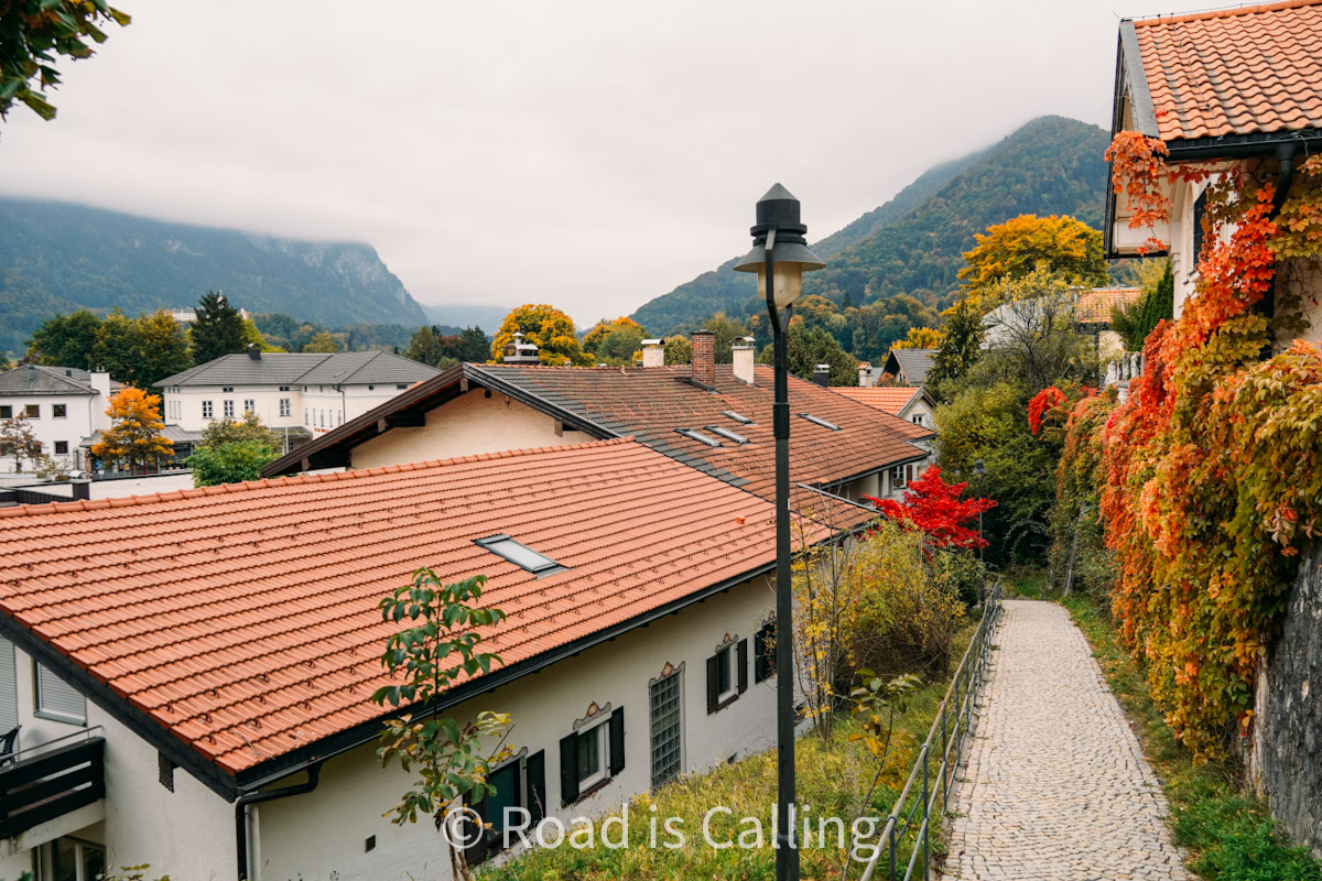 view of pathway with alpine mountain views and traditional houses in Aschau im Chiemgau village