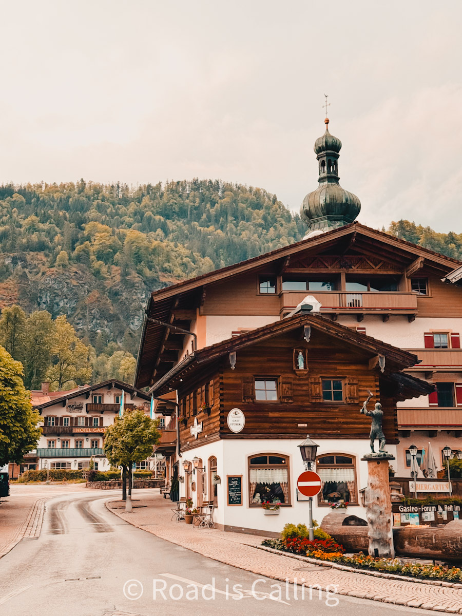 wooden alpine houses in a Bavarian village surrounded by mountain scenery