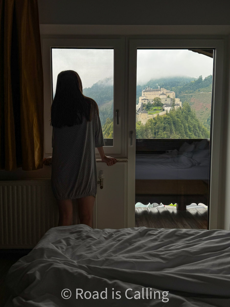me standing by the window in a guesthouse in Werfen village in the alps