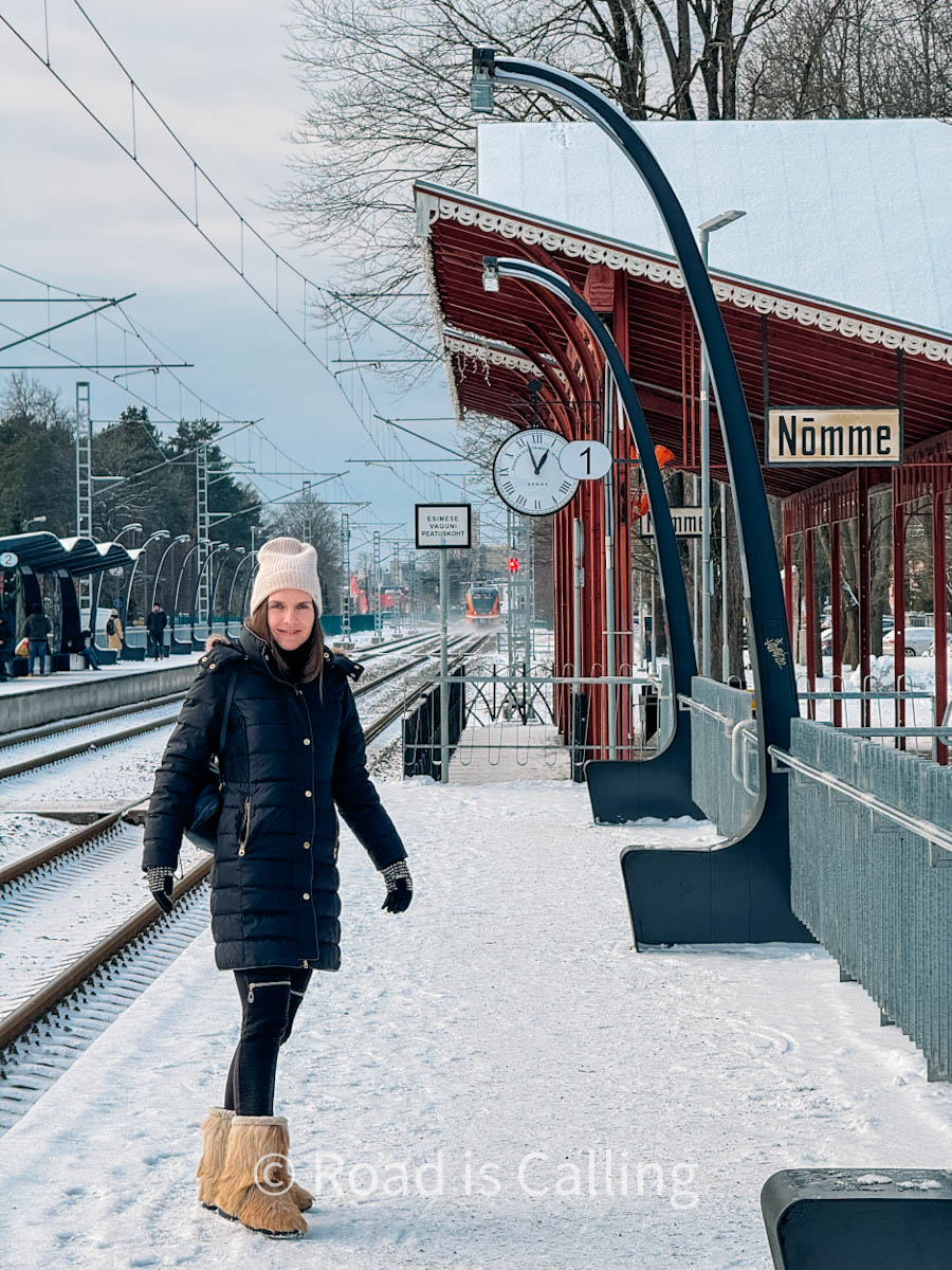 woman is standing on the train station in Nomme neighborhood in Winter