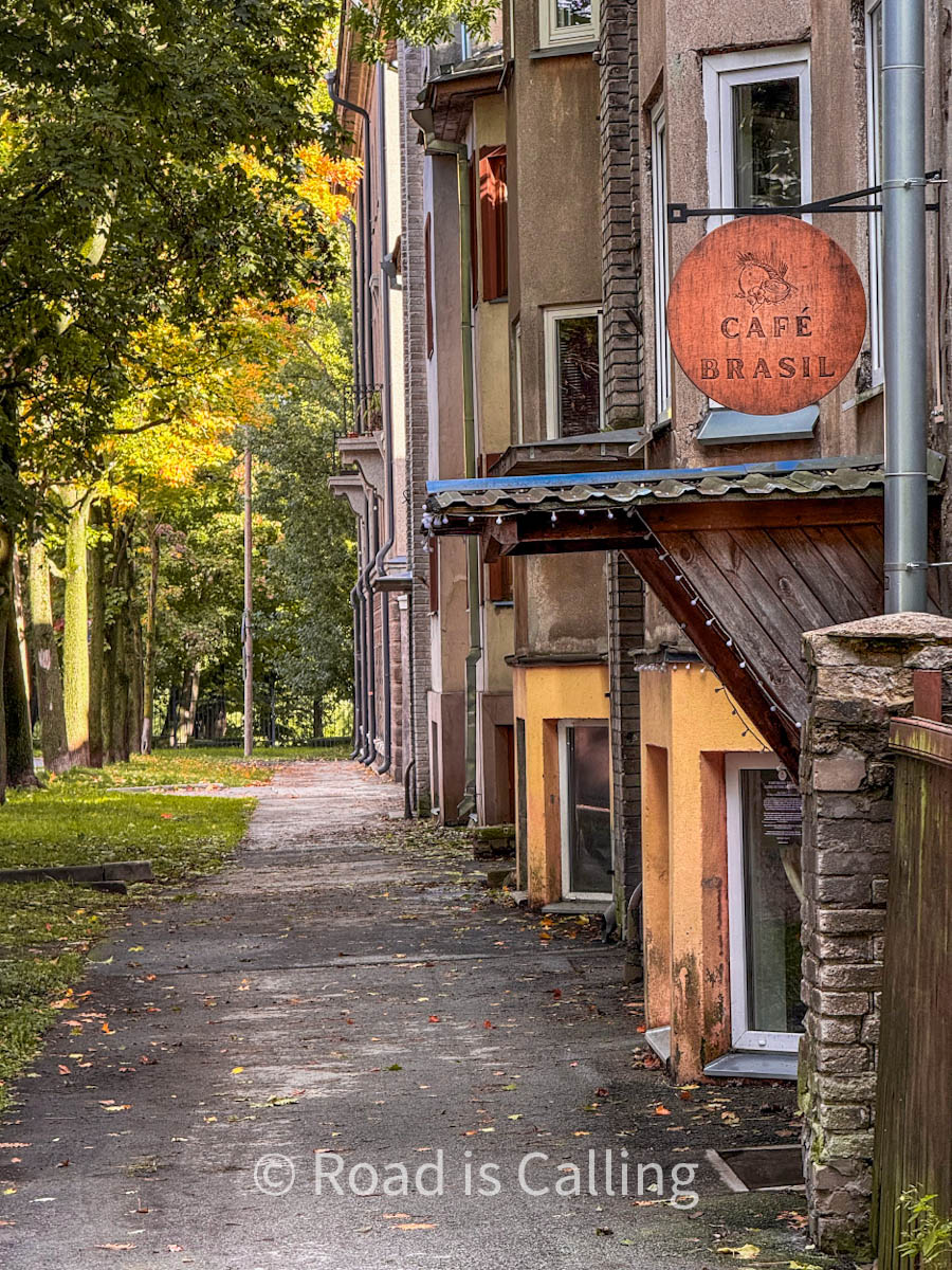 a green street with houses and a cafe in Tallinn