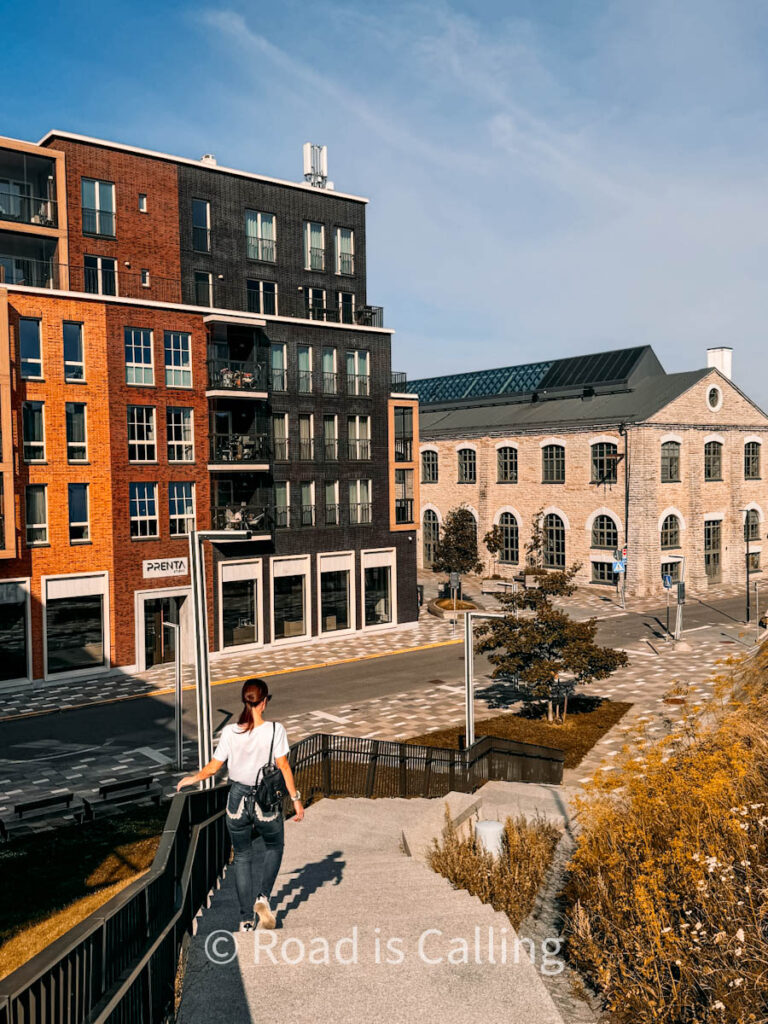 girl is walking down the stairs in Noblessner, one of the best areas where to stay in Tallinn