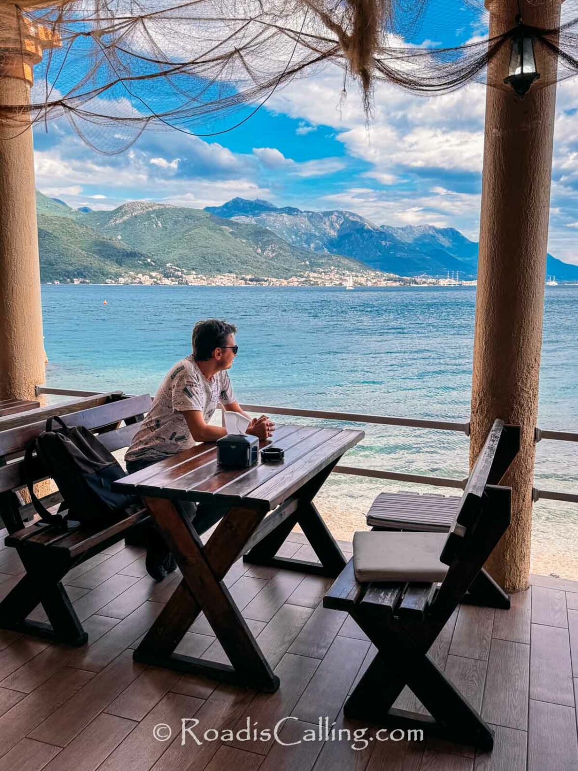 man sitting at the table in tavern by the sea in Bijela Montenegro