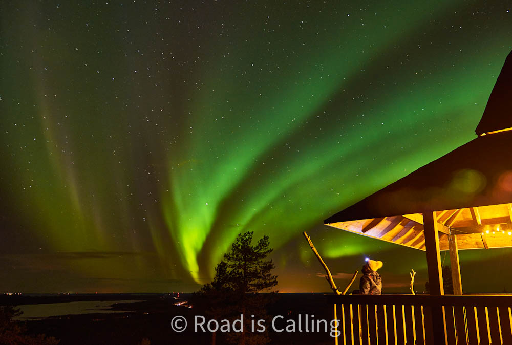 Northern lights above wooden lookout hut in Rovaniemi Lapland Finland