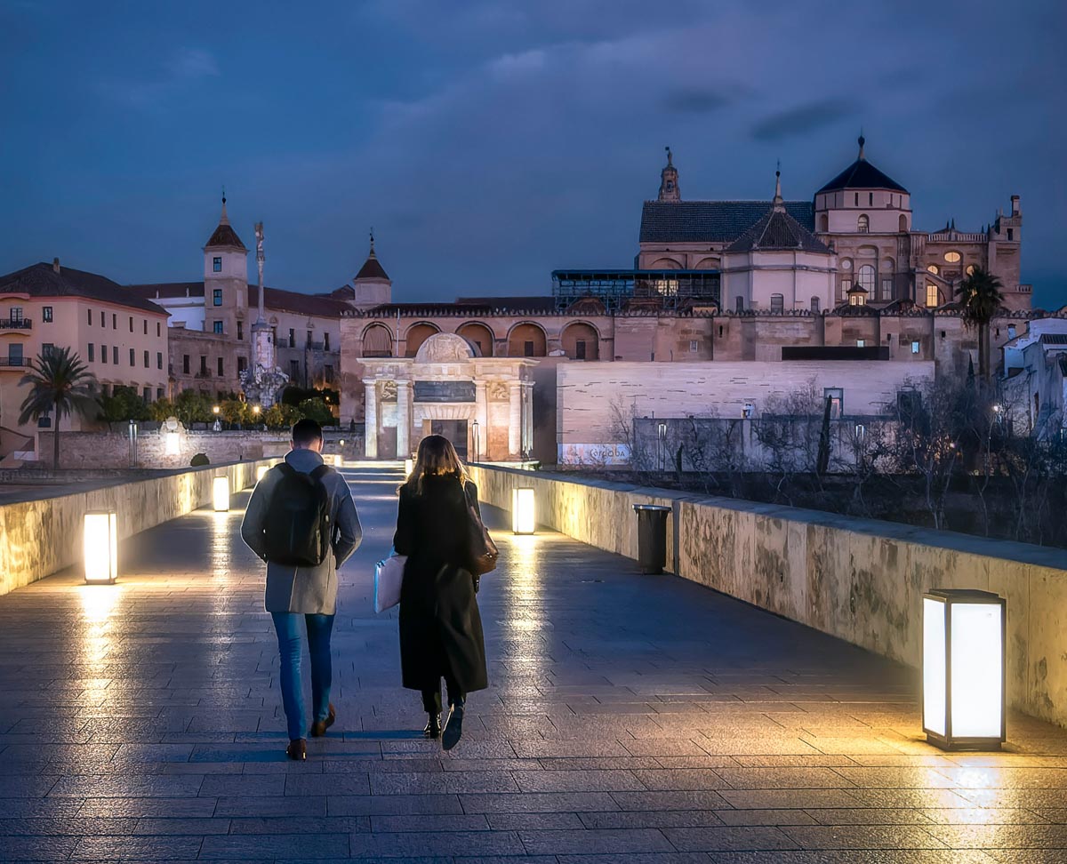people of walking on the night bridge in Cordoba