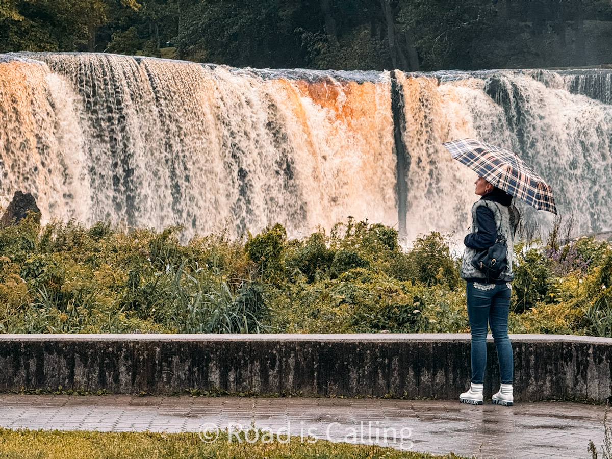 me walking under the umbrella by the Keila waterfall on a trip in Estonia