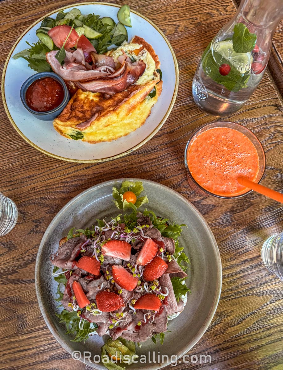 breakfast dishes with a carrot juice on a table in Tallinn cafe 