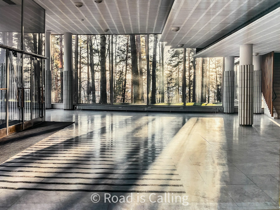 Modern lobby interior with large glass windows and forest view in Jyväskylä, Finland