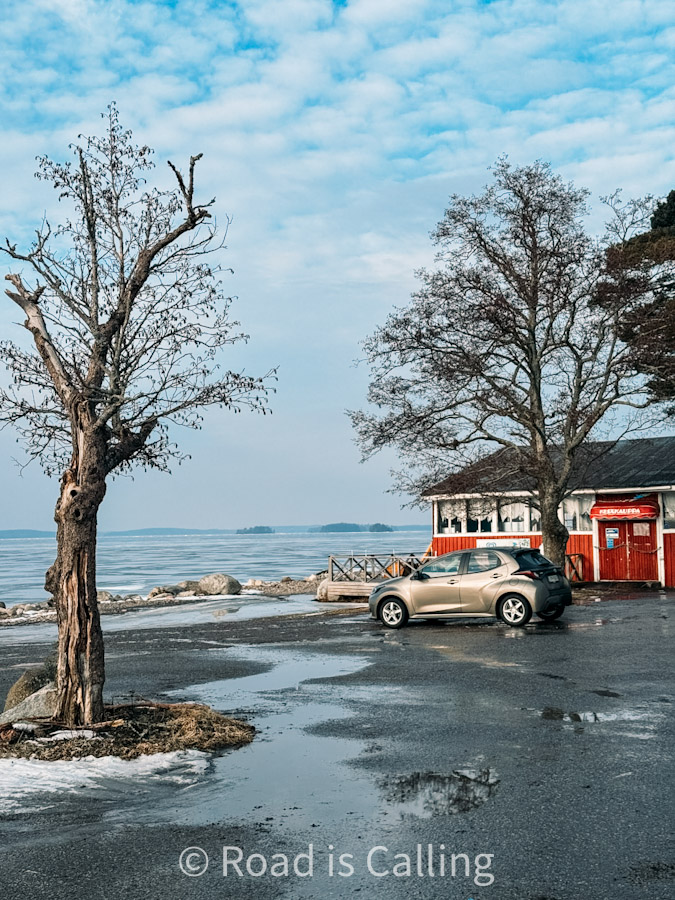Car parked near lakeside restaurant on a winter day in Jyväskylä, Finland