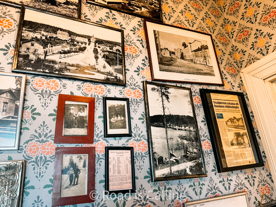 Vintage black and white photographs on wall in Finnish museum café