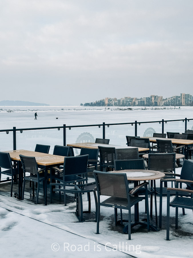 Snow-covered outdoor café terrace with frozen lake view in Jyväskylä Finland