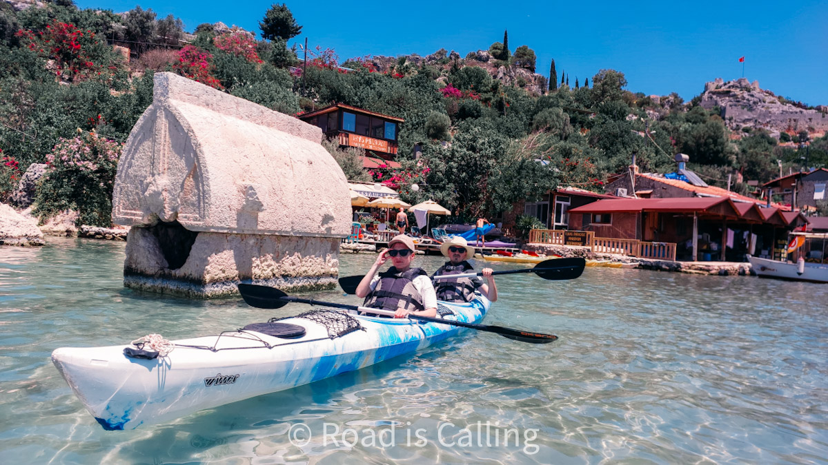 Couple kayaking near a Lycian sarcophagus in the sea in the village of Kekova, Turkey