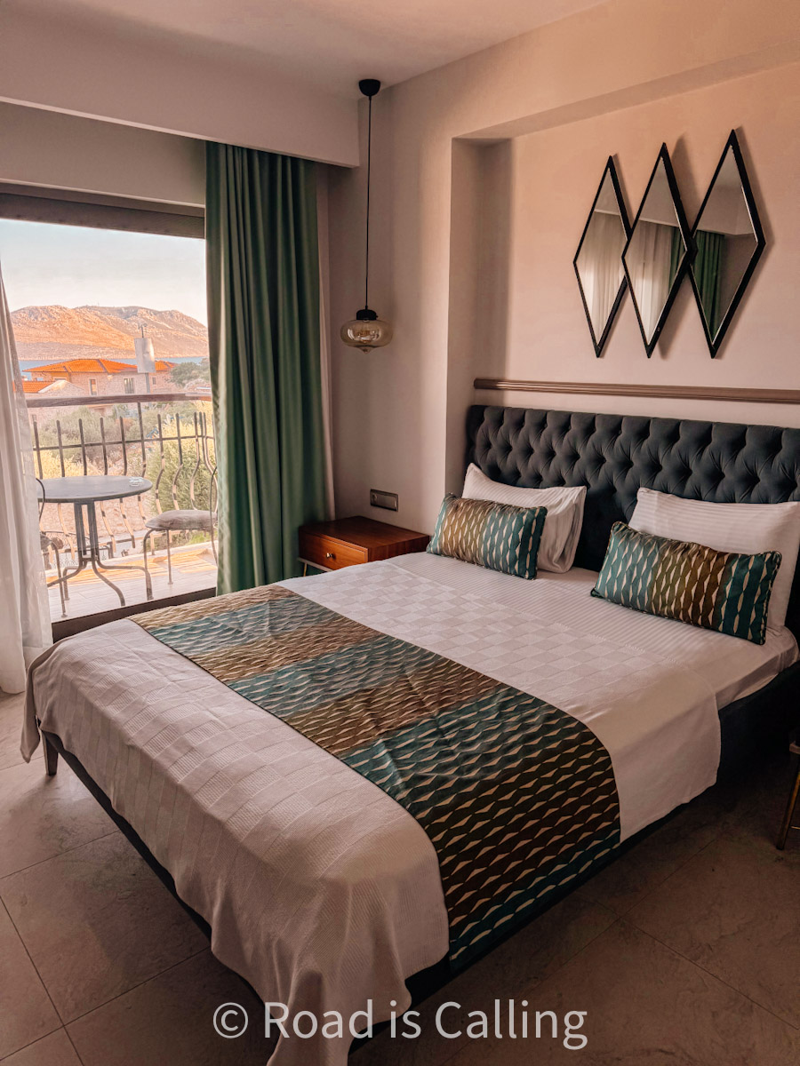 view of the bed in the hotel room by the window