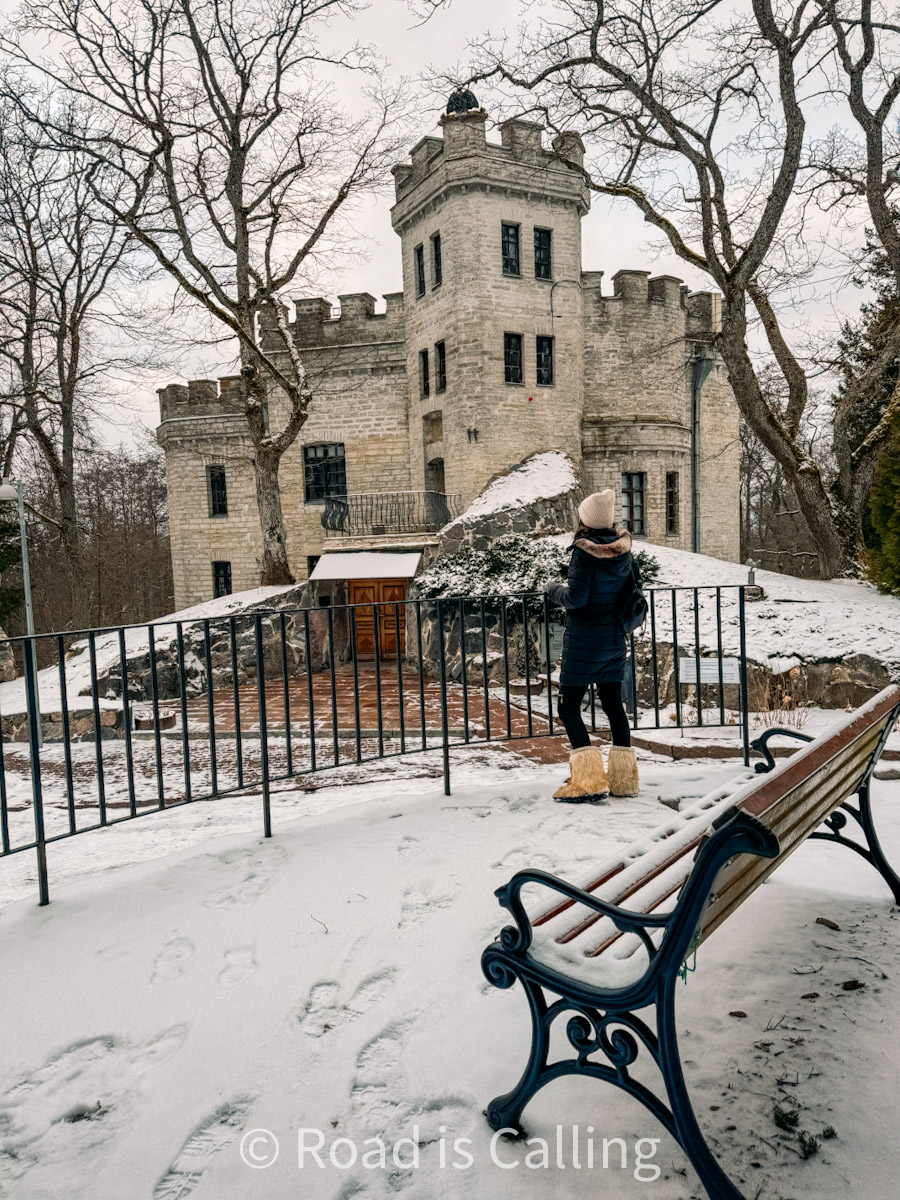 me standing by the bench and fence near the Glen Castle in winter