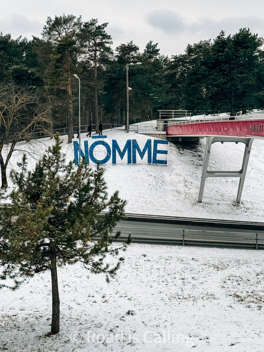 view of the Nomme sign by the bridge and road