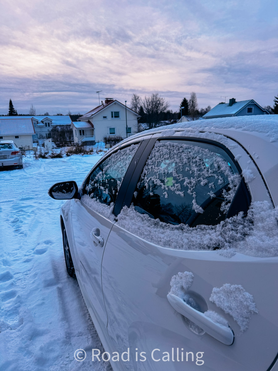 Rental car in Rovaniemi covered with snow in a residential area