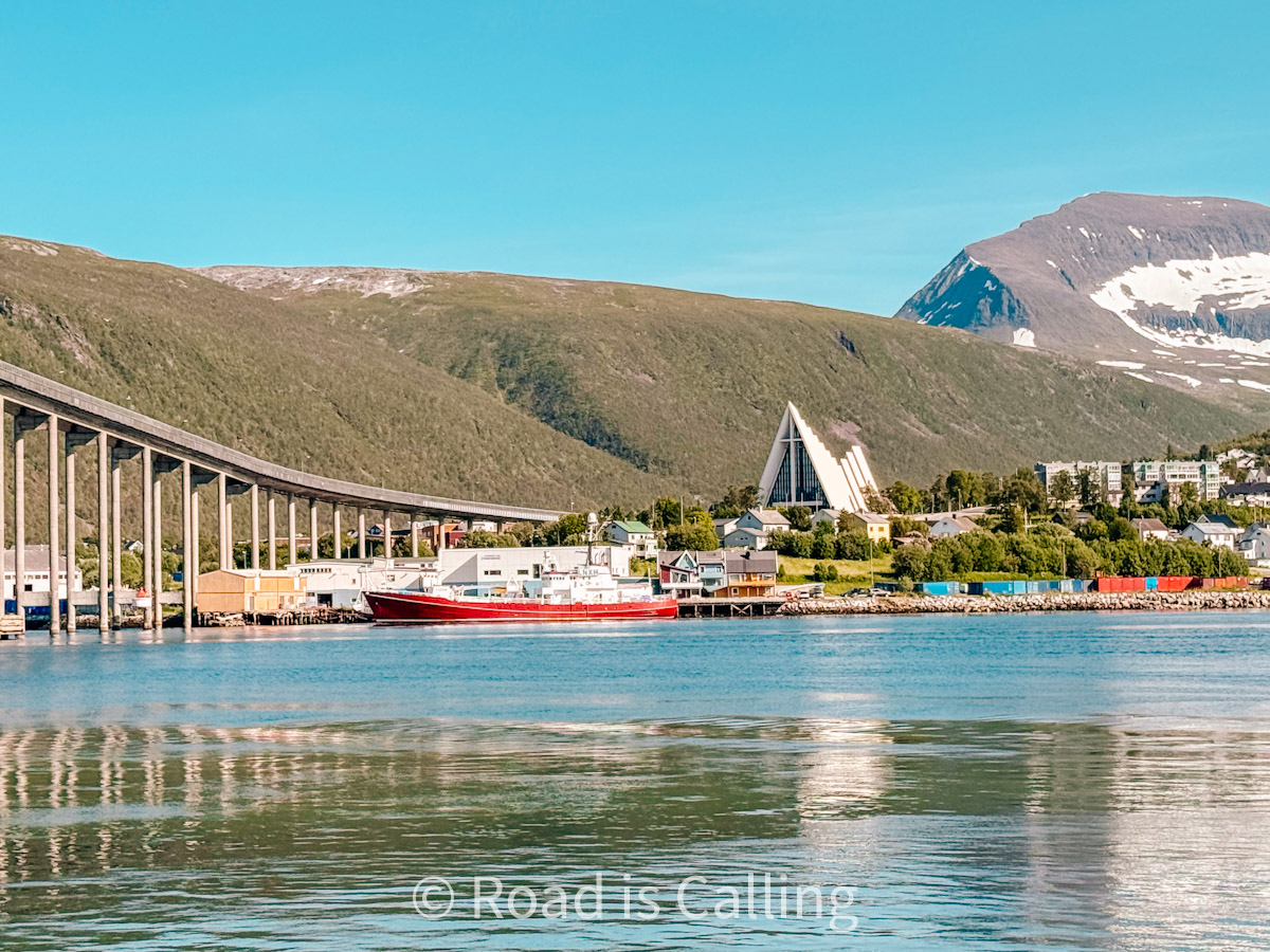view of Tromso Аrctic church, main bridge, and sea in July