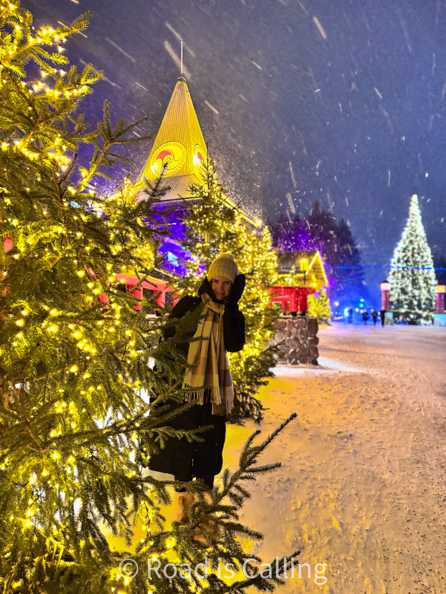 Woman standing by Christmas lights in Santa Claus Village, Rovaniemi