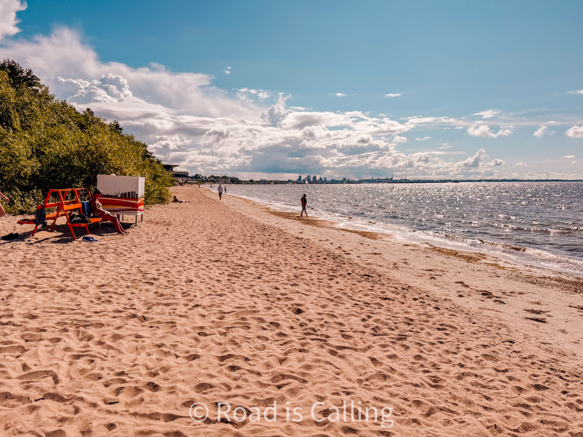 Peaceful Pirita Beach in Tallinn on a sunny day with a view of the Baltic Sea and city skyline