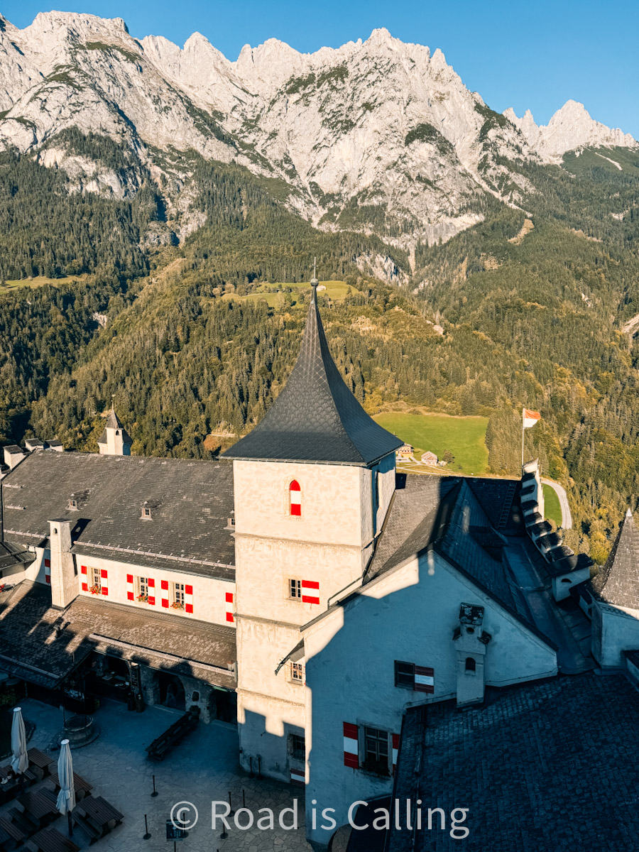 Hohenwerfen Fortress with dramatic alpine mountain backdrop in Werfen village