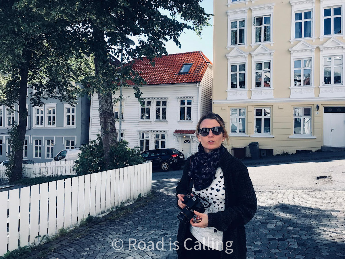 me posing in front of the colorful houses in Bergen Norway