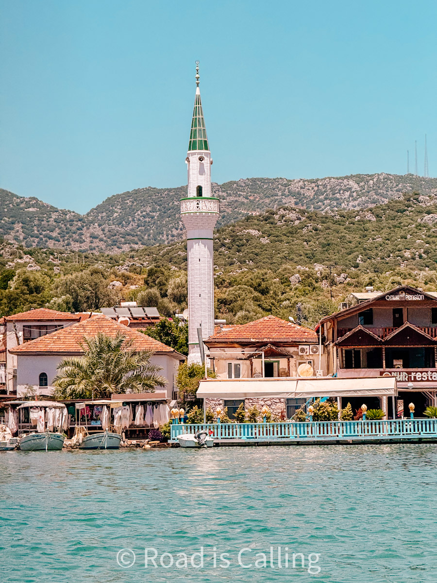 View of a waterfront mosque and local houses in the village of Kaleköy (Simena), Turkey, seen from the sea