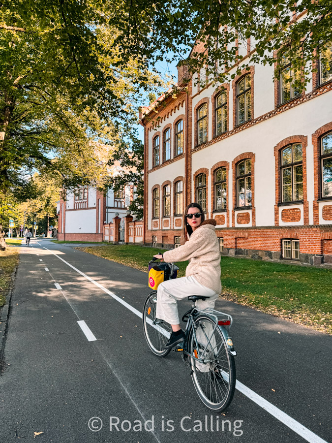 me on a bike by a colorful building in Parnu