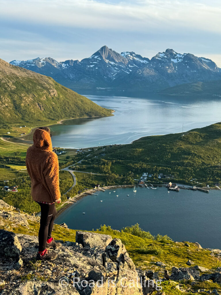 me standing on the mountain overlooking fjord near Tromso