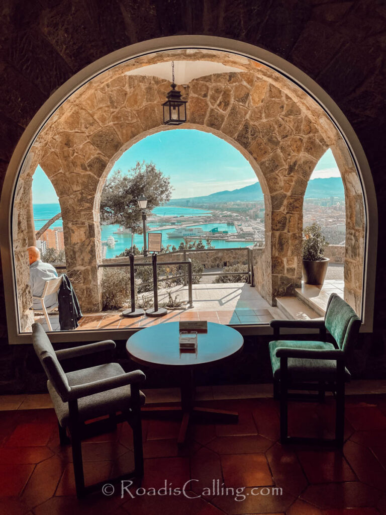 view of Malaga from the hisotirc hotel through stone arches in winter